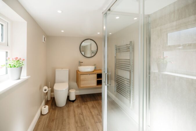 Contemporary shower room with walk-in glass enclosure and neutral tones at The Hideaway
