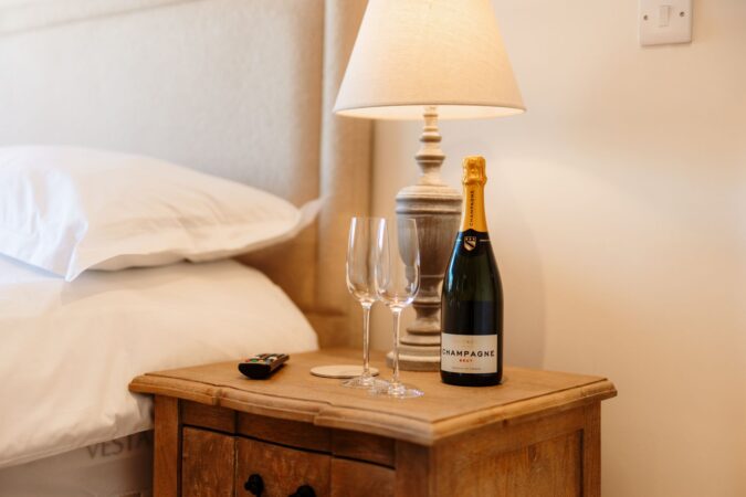 Stylish king-size bedroom with soft coastal-themed decor at The Hideaway in Whitby