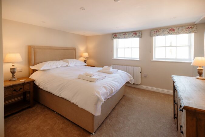 Bright and airy king-size bedroom with rooftop views from the second floor at The Hideaway