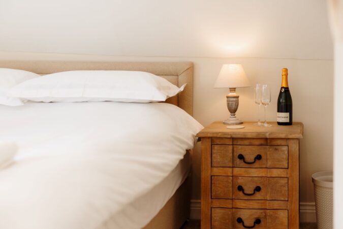 Loft king-size bedroom with sloped ceilings at The Hideaway holiday cottage