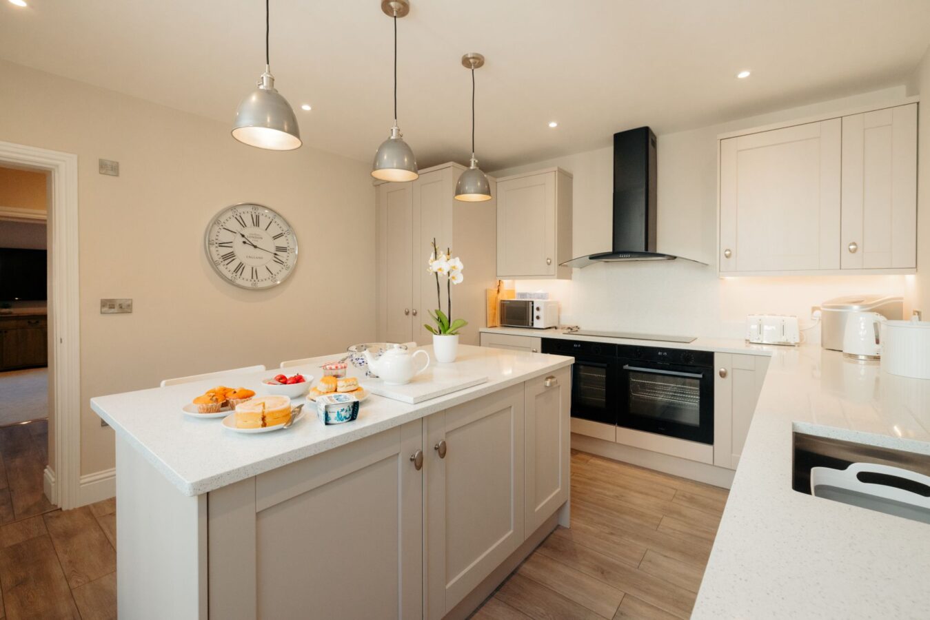 Modern kitchen with large breakfast island with seating at The Hideaway holiday cottage