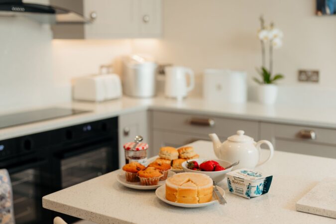 Modern kitchen with large breakfast island with seating at The Hideaway holiday cottage