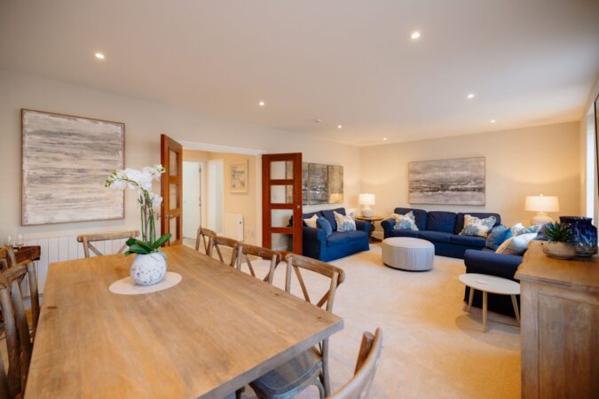 Comfortable and stylish living room with sofas and fireplace at The Hideaway cottage