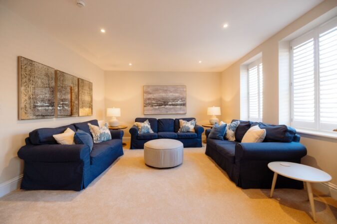 Comfortable and stylish living room with sofas and fireplace at The Hideaway cottage
