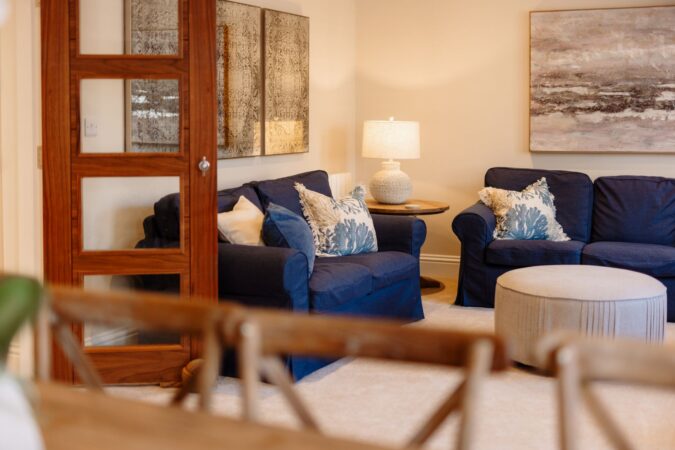 Comfortable and stylish living room with sofas and fireplace at The Hideaway cottage