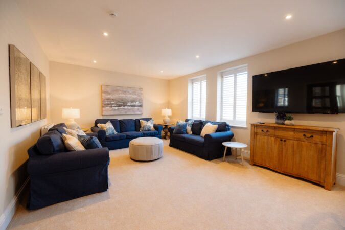 Comfortable and stylish living room with sofas and fireplace at The Hideaway cottage