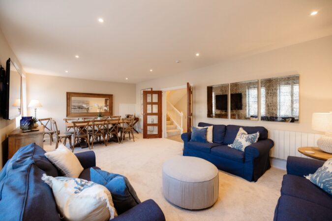 Comfortable and stylish living room with sofas and fireplace at The Hideaway cottage